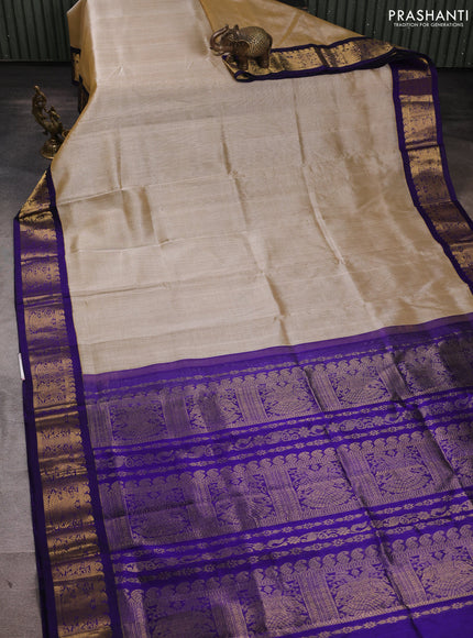 Silk cotton saree beige and violet with plain body and zari woven korvai border
