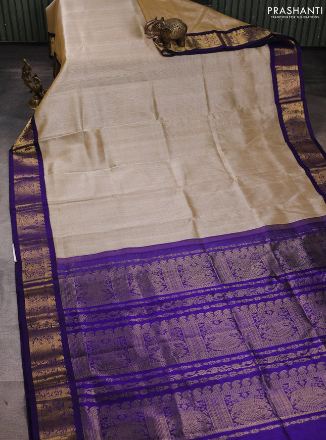 Silk cotton saree beige and violet with plain body and zari woven korvai border