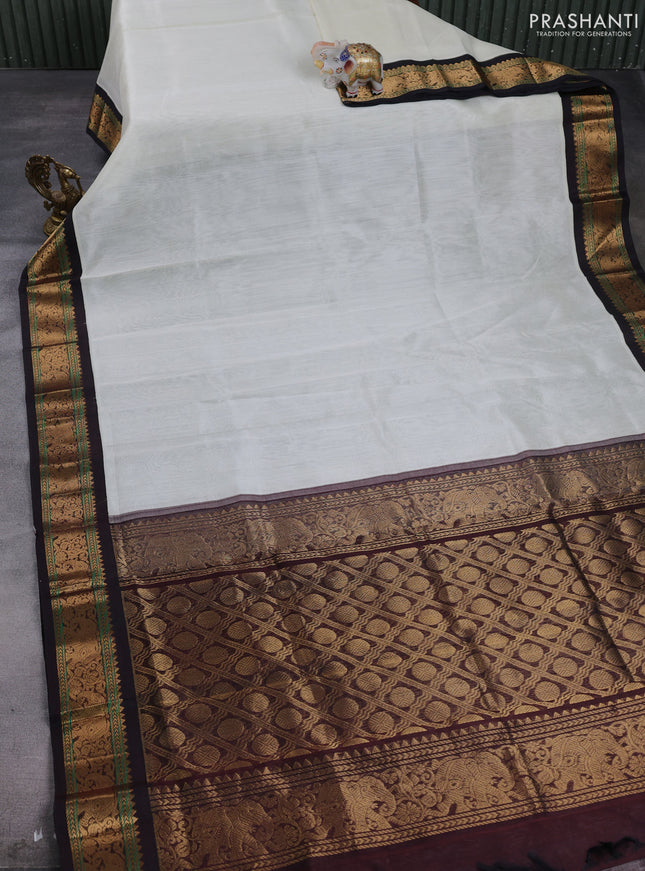 Silk cotton saree off white and deep maroon with plain body and zari woven elephant korvai border