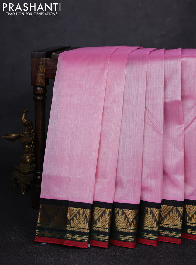 Silk cotton saree light pink and black with plain body and temple design zari woven korvai border