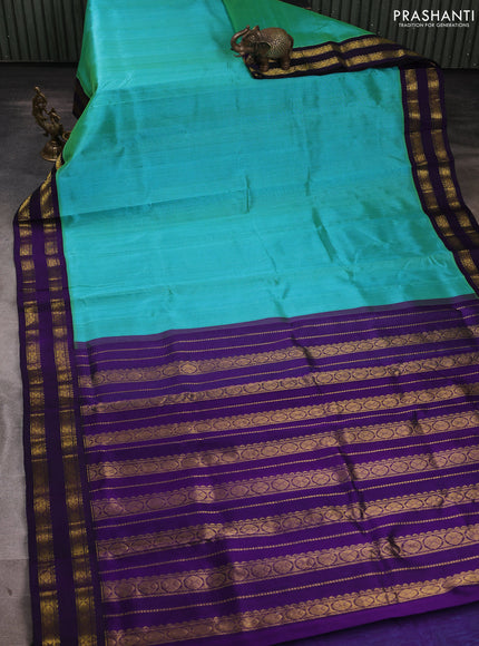 Silk cotton saree dual shade of teal green and violet with plain body and rettapet zari woven korvai border