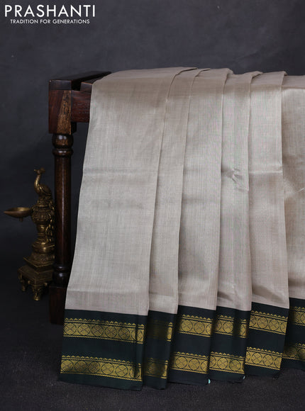 Silk cotton saree grey and bottle green with plain body and rettapet zari woven korvai border