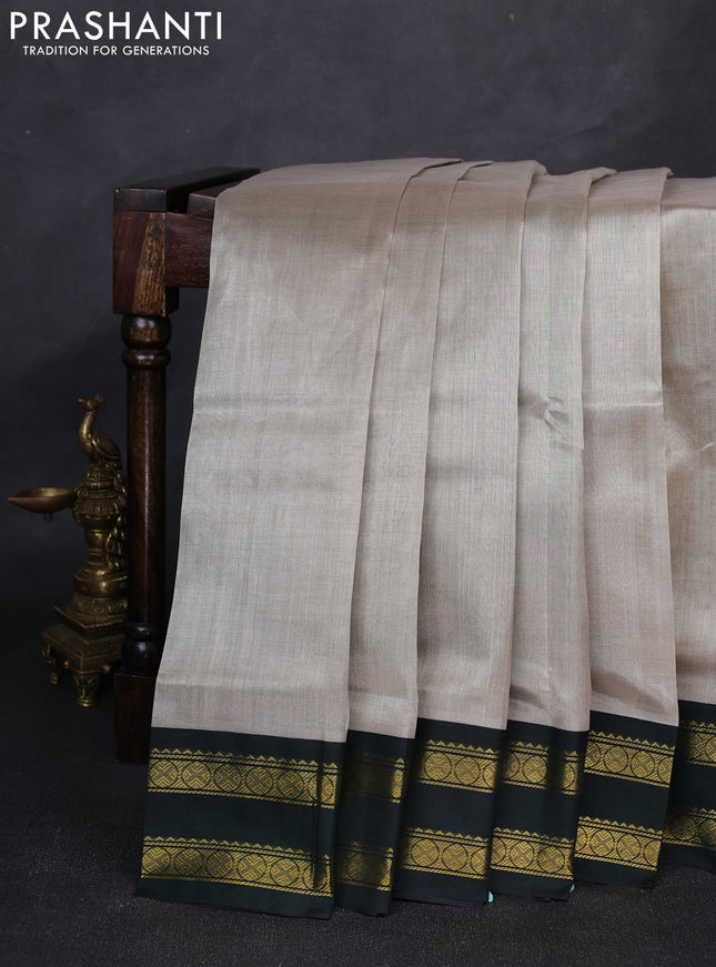 Silk cotton saree grey and bottle green with plain body and rettapet zari woven korvai border
