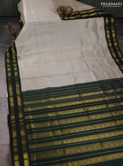 Silk cotton saree grey and bottle green with plain body and rettapet zari woven korvai border