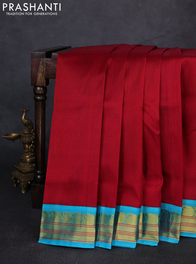 Silk cotton saree maroon and teal blue with plain body and paisley zari woven korvai border