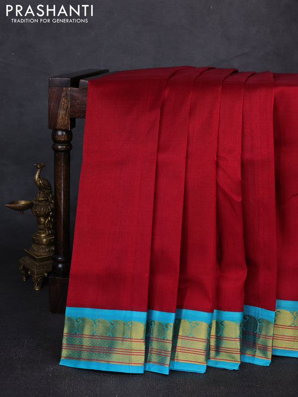 Silk cotton saree maroon and teal blue with plain body and paisley zari woven korvai border