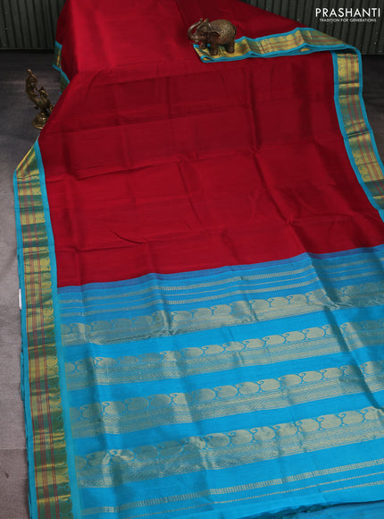 Silk cotton saree maroon and teal blue with plain body and paisley zari woven korvai border
