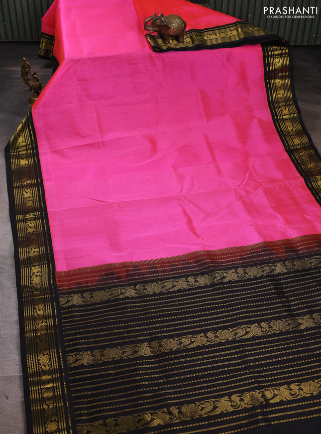 Silk cotton saree dark peach and black with plain body and zari woven korvai border