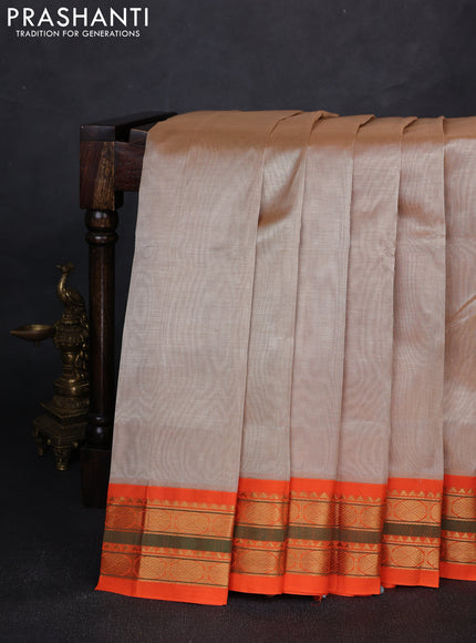 Silk cotton saree beige and orange with plain body and zari woven korvai border