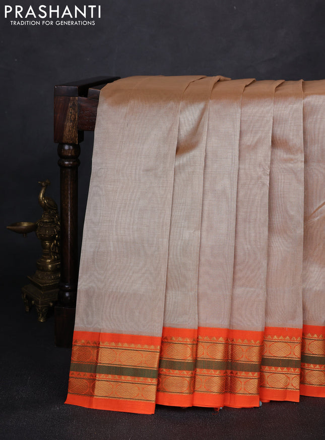 Silk cotton saree beige and orange with plain body and zari woven korvai border