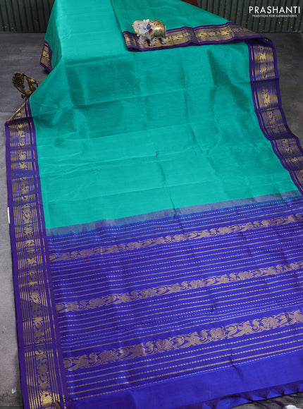 Silk cotton saree teal green and navy blue with plain body and zari woven korvai border
