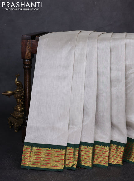 Silk cotton saree grey and green with plain body and zari woven korvai border