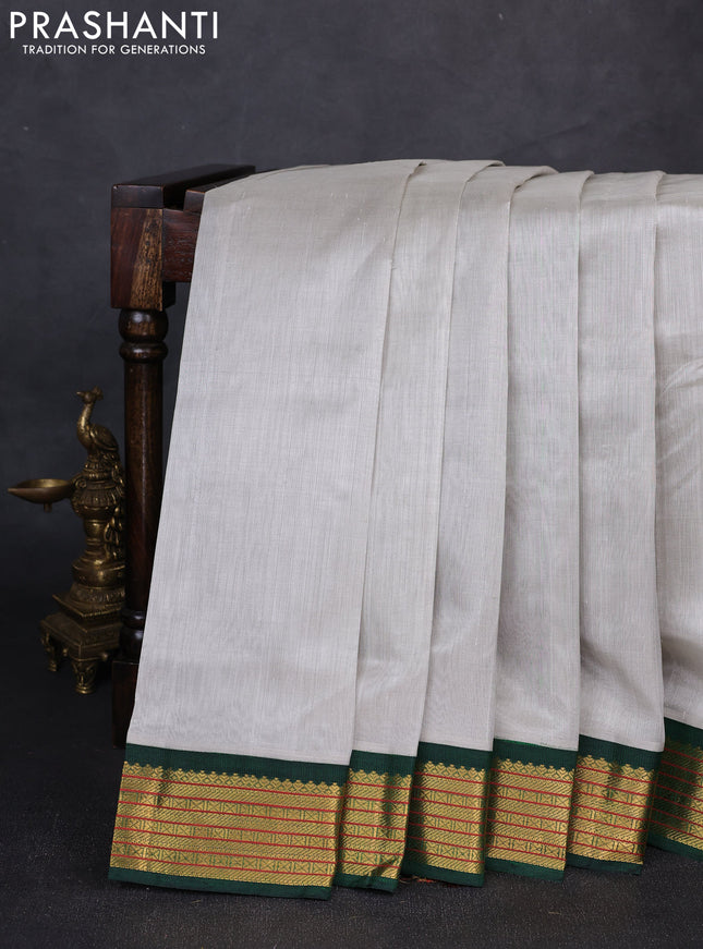 Silk cotton saree grey and green with plain body and zari woven korvai border