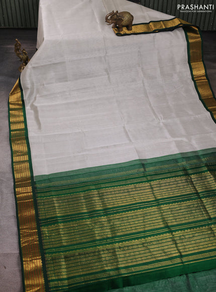 Silk cotton saree grey and green with plain body and zari woven korvai border