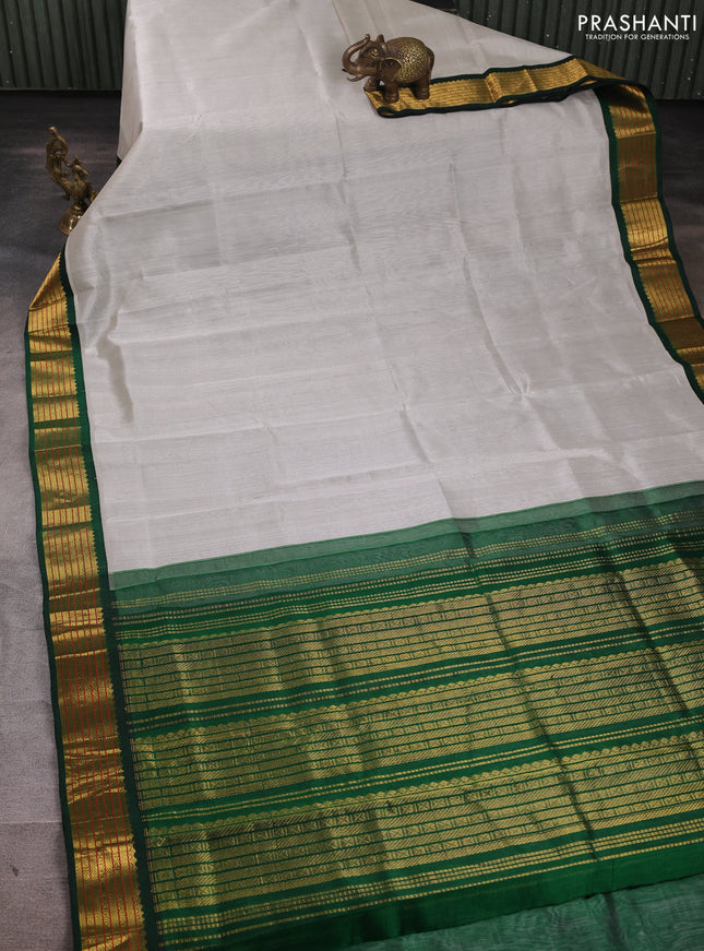 Silk cotton saree grey and green with plain body and zari woven korvai border