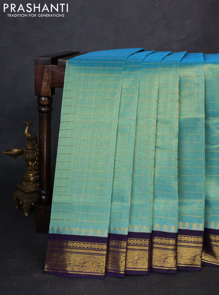 Silk cotton saree dual shade of teal green and violet with allover zari checked pattern and zari woven korvai border