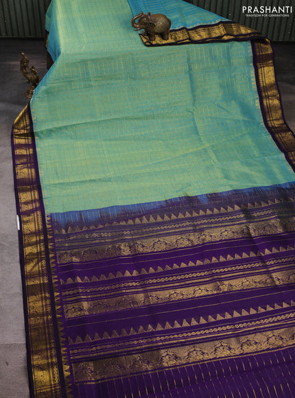 Silk cotton saree dual shade of teal green and violet with allover zari checked pattern and zari woven korvai border