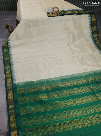 Silk cotton saree cream and bottle green with allover zari checks & laksha deepam buttas and temple design zari woven korvai border