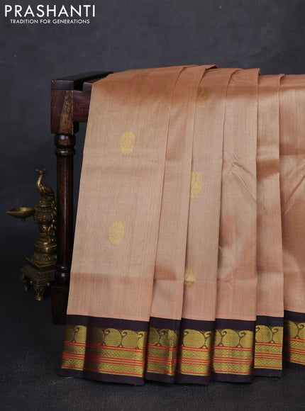 Silk cotton saree beige and coffee brown with allover peacock zari woven buttas and paisley zari woven korvai border