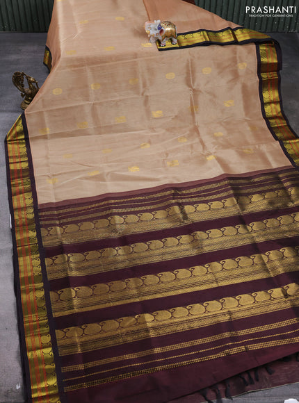 Silk cotton saree beige and coffee brown with allover peacock zari woven buttas and paisley zari woven korvai border