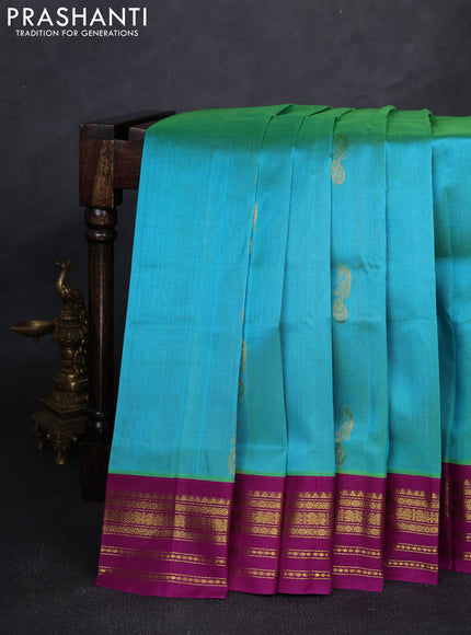 Silk cotton saree dual shade of teal blue and purple with peacock zari woven buttas and zari woven korvai border