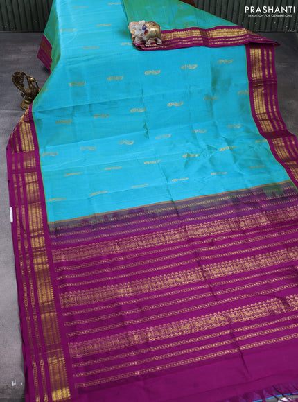 Silk cotton saree dual shade of teal blue and purple with peacock zari woven buttas and zari woven korvai border