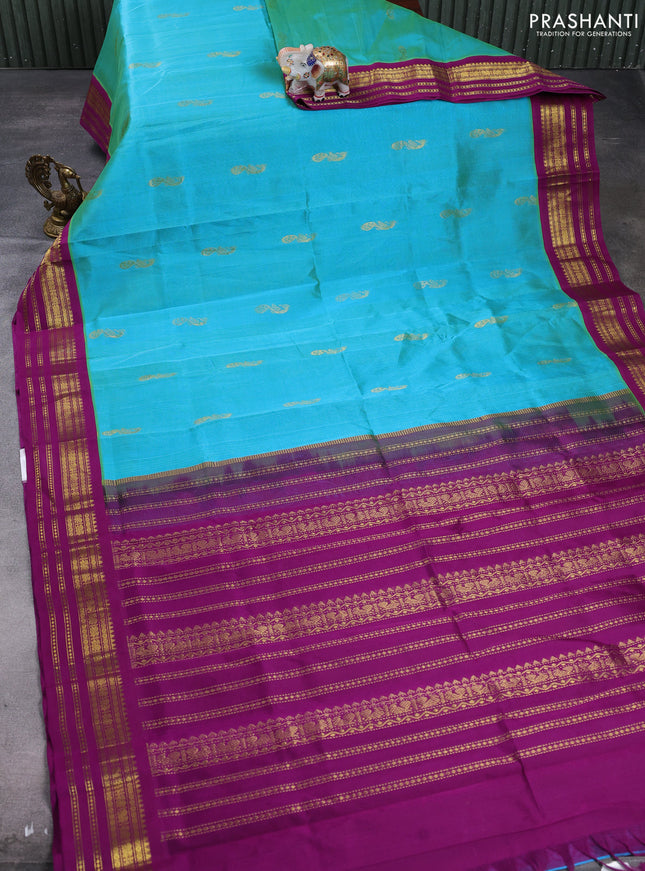 Silk cotton saree dual shade of teal blue and purple with peacock zari woven buttas and zari woven korvai border