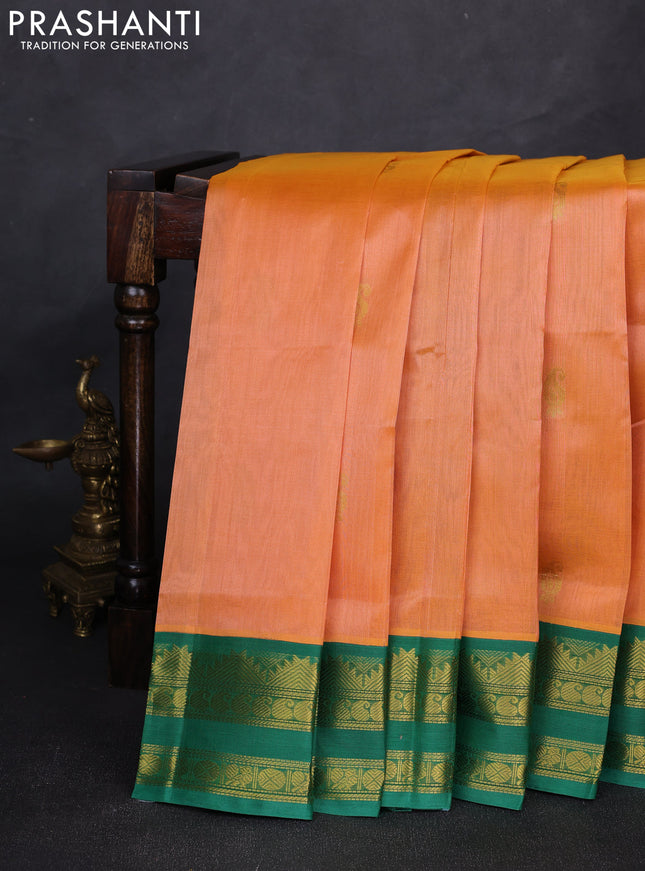 Silk cotton saree pale orange and green with allover paisley zari woven buttas and temple design rettapet zari woven korvai border