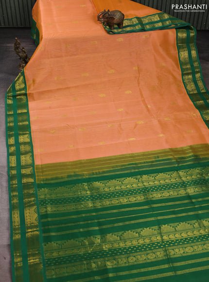 Silk cotton saree pale orange and green with allover paisley zari woven buttas and temple design rettapet zari woven korvai border