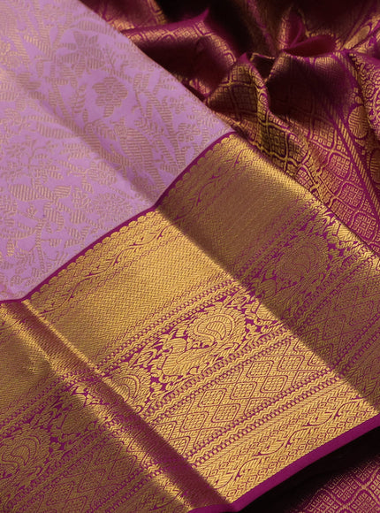 Pure kanchipuram silk saree mild lavender and purple with allover zari woven brocade weaves and long rich zari woven border