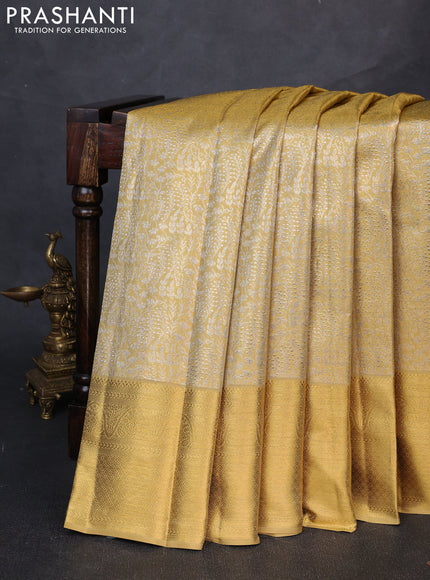 Pure kanchipuram tissue silk saree gold with allover zari woven brocade weaves and long rich zari woven border