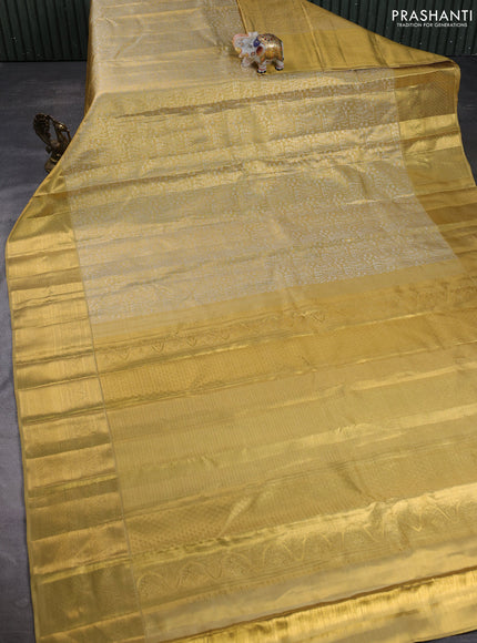 Pure kanchipuram tissue silk saree gold with allover zari woven brocade weaves and long rich zari woven border