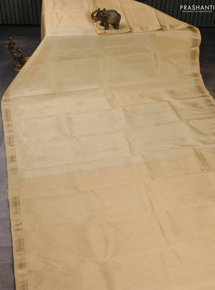 Pure kanchipuram silk saree cream with zari woven buttas and small zari woven border