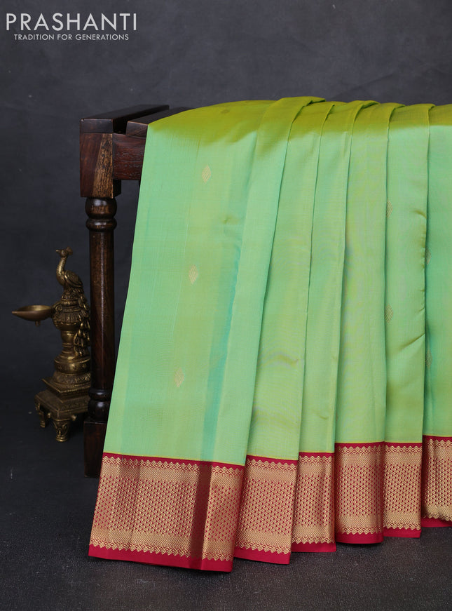 Pure kanchipuram silk saree dual shade of teal green and maroon with allover zari woven buttas and zari woven korvai border