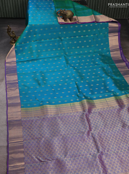 Pure kanchipuram silk saree dual shade of teal green and purple with allover zari woven buttas and zari woven border