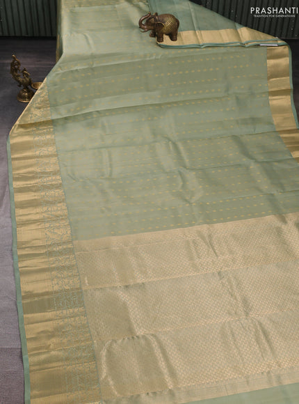 Pure kanchipuram silk saree pastel green with allover zari woven buttas and long zari woven border