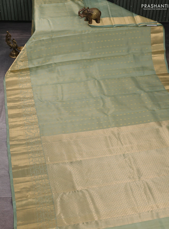 Pure kanchipuram silk saree pastel green with allover zari woven buttas and long zari woven border