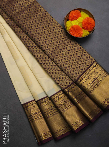 Semi kanchipuram silk saree cream and deep wine shade with zari woven buttas and long zari woven korvai border
