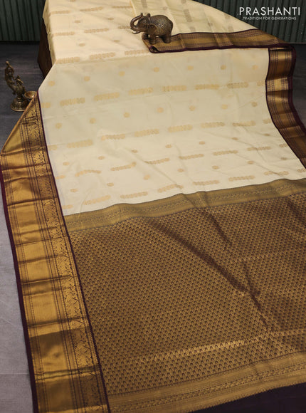 Semi kanchipuram silk saree cream and deep wine shade with zari woven buttas and long zari woven korvai border