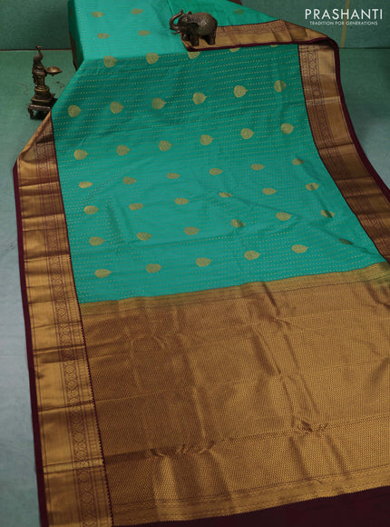 Semi kanchipuram silk saree teal green and deep maroon with allover zari woven 1000 buttas and zari woven border