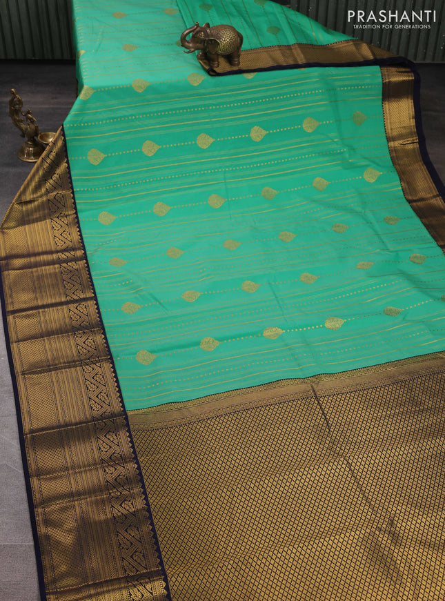 Semi kanchipuram silk saree teal green and navy blue with allover zari weaves & buttas and long zari woven korvai border