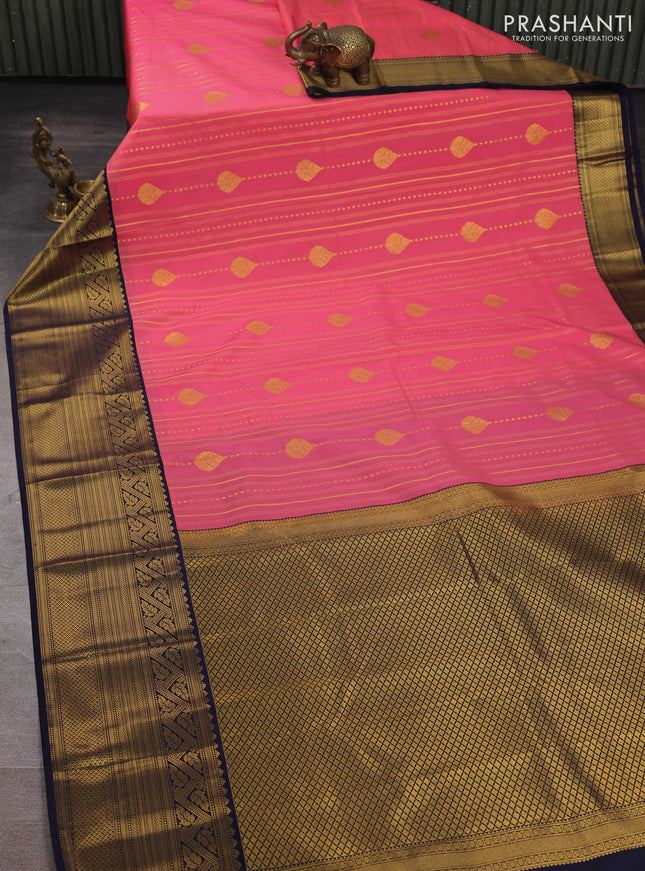 Semi kanchipuram silk saree peach pink and navy blue with allover zari weaves & buttas and long zari woven korvai border