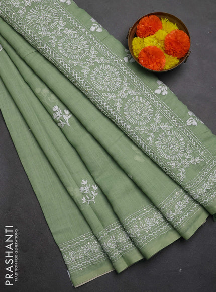 Khadi linen cotton saree pastel green with floral embroidery buttas and kantha stitch work pallu & border