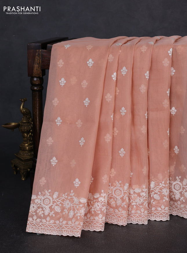 Organza saree peach shade with embroidery buttas and embroidery border