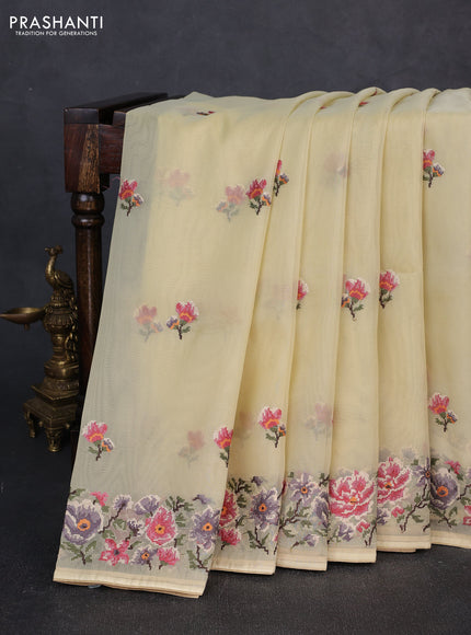 Organza saree pale yellow with embroidery buttas and convent embroidery border