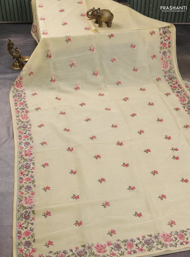 Organza saree pale yellow with embroidery buttas and convent embroidery border