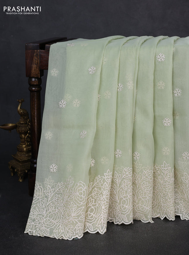 Organza saree pista green with embroidery buttas and floral embroidery border