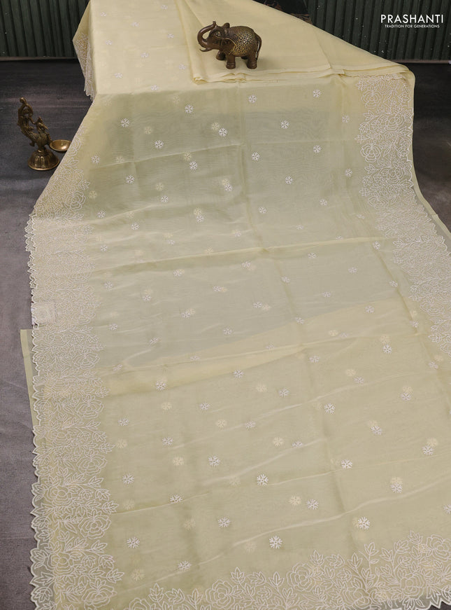 Organza saree pale yellow with embroidery buttas and floral embroidery border