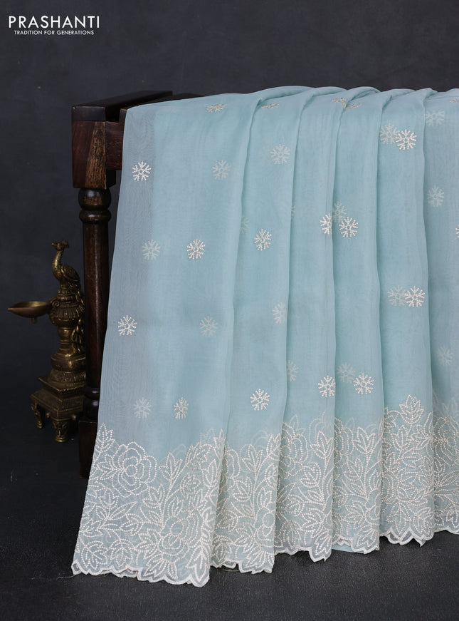 Organza saree light blue with embroidery buttas and floral embroidery border