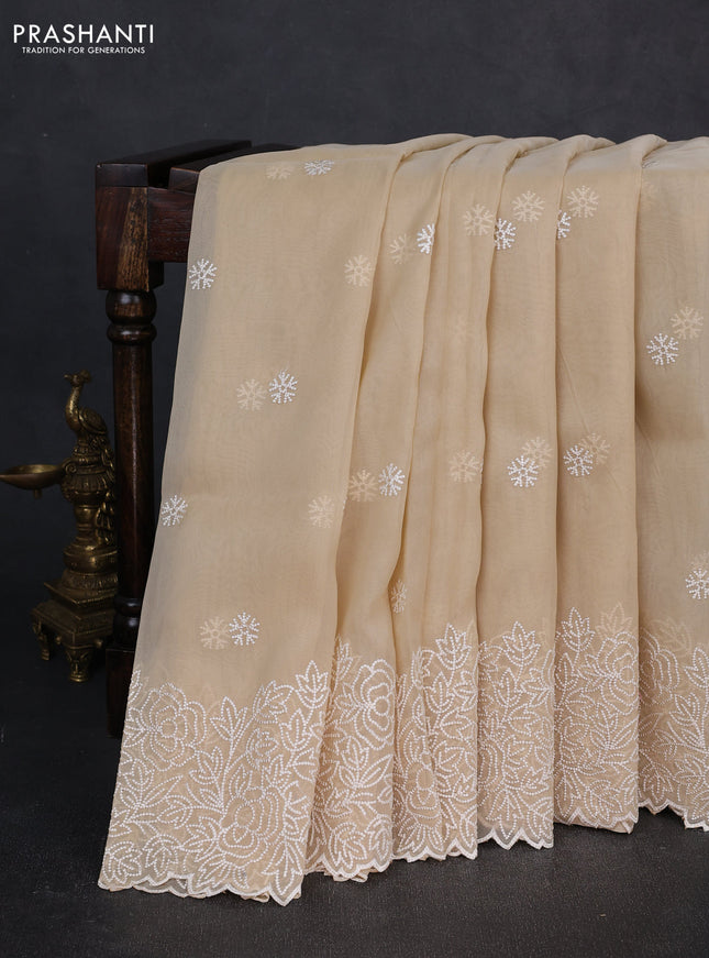 Organza saree beige with embroidery buttas and floral embroidery border